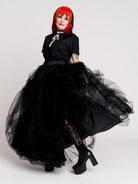 a voluminous layered black tulle skirt. 