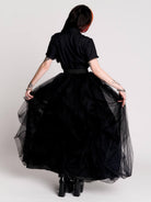 a voluminous layered black tulle skirt. 
