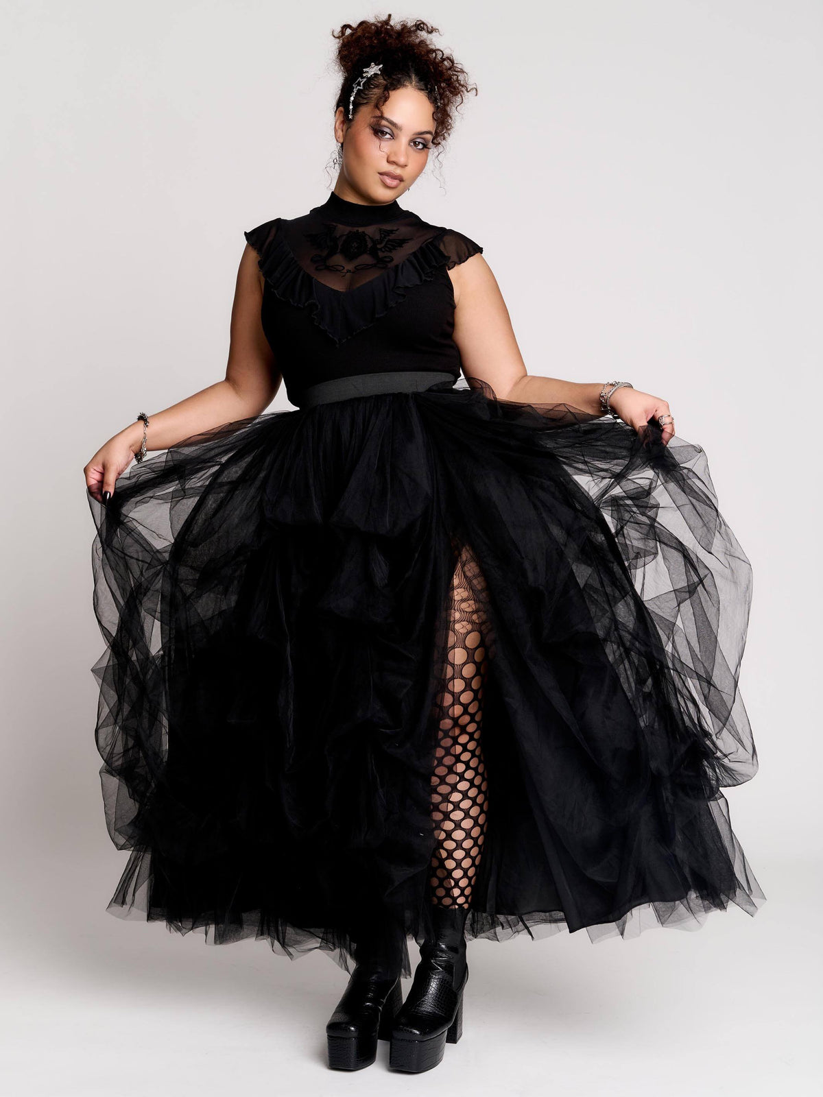 a voluminous layered black tulle skirt. 