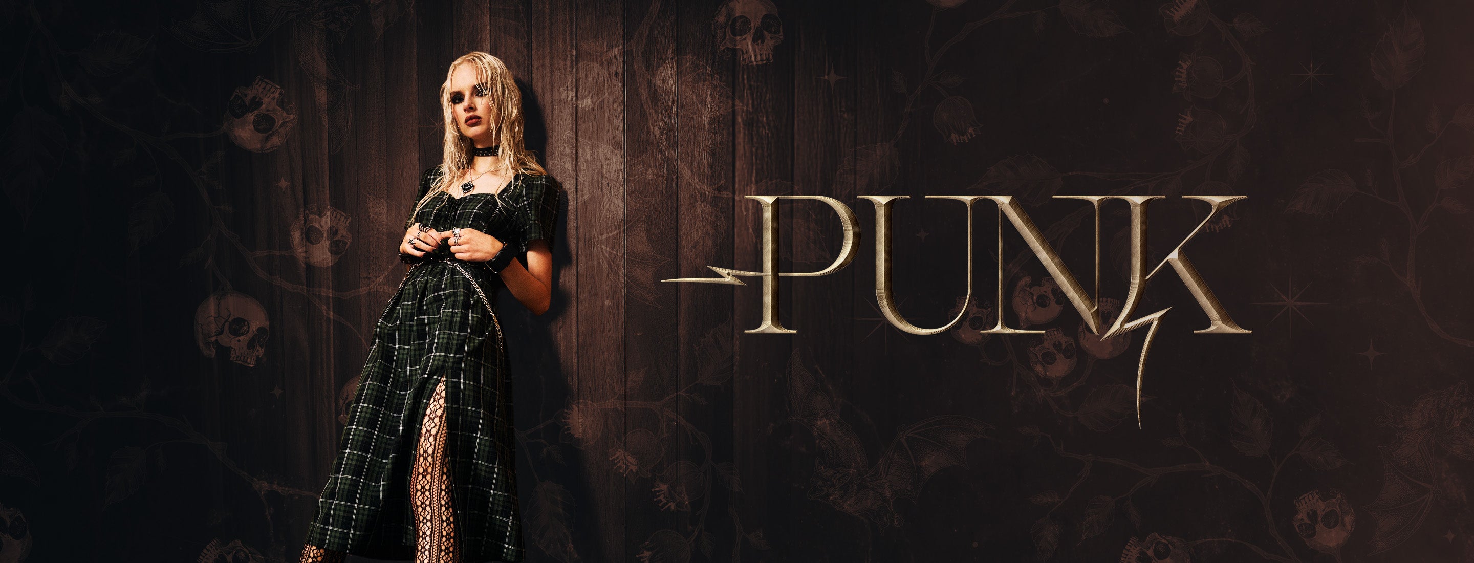 Person in a dark, gothic outfit with 'PUNK' text on a dark background