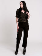 A short-sleeve button-up blouse featuring a dark green and black gothic pattern with pink accents.