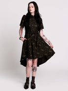 a short-sleeved high-low dress in black with a small red and green floral pattern.