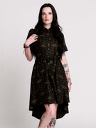 a short-sleeved high-low dress in black with a small red and green floral pattern.