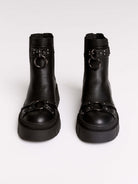 Black chunky platform ankle boots with buckle straps.