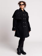 a black double-breasted coat with silver buttons and gothic dragon embroidery on the shoulder cape