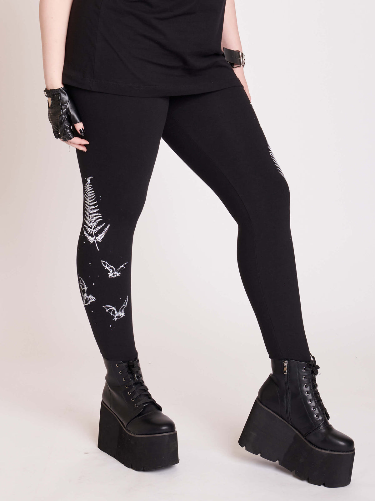 Witchy broom stick graphic on black leggings