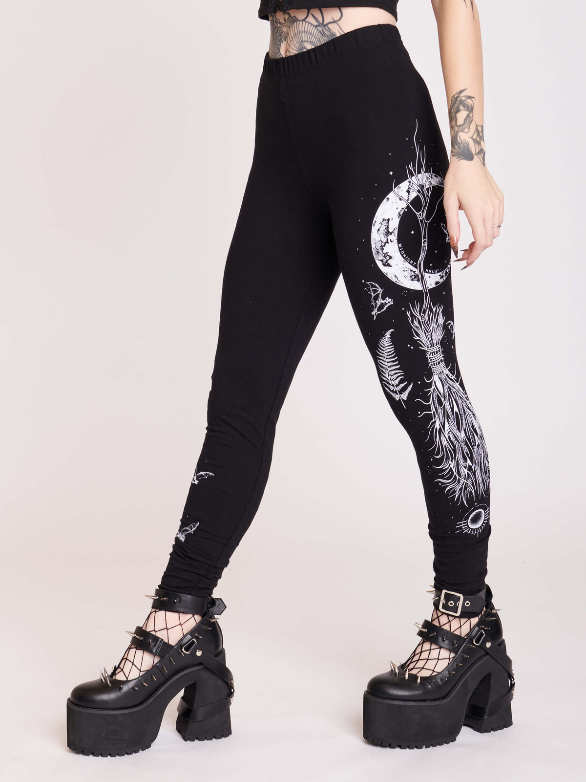 Witchy broom stick graphic on black leggings