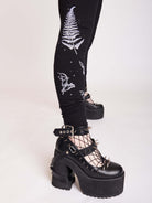 Witchy broom stick graphic on black leggings