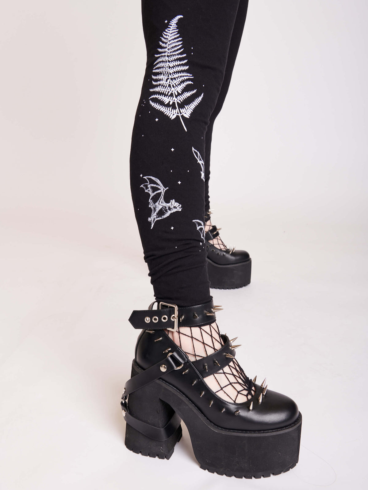 Witchy broom stick graphic on black leggings